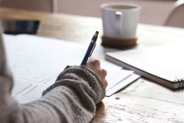 Writer adapting creative content by hand with notes