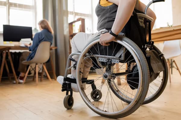 Wheelchair user working in an accessible office space