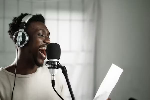 Voice artist recording a dubbing performance into a microphone
